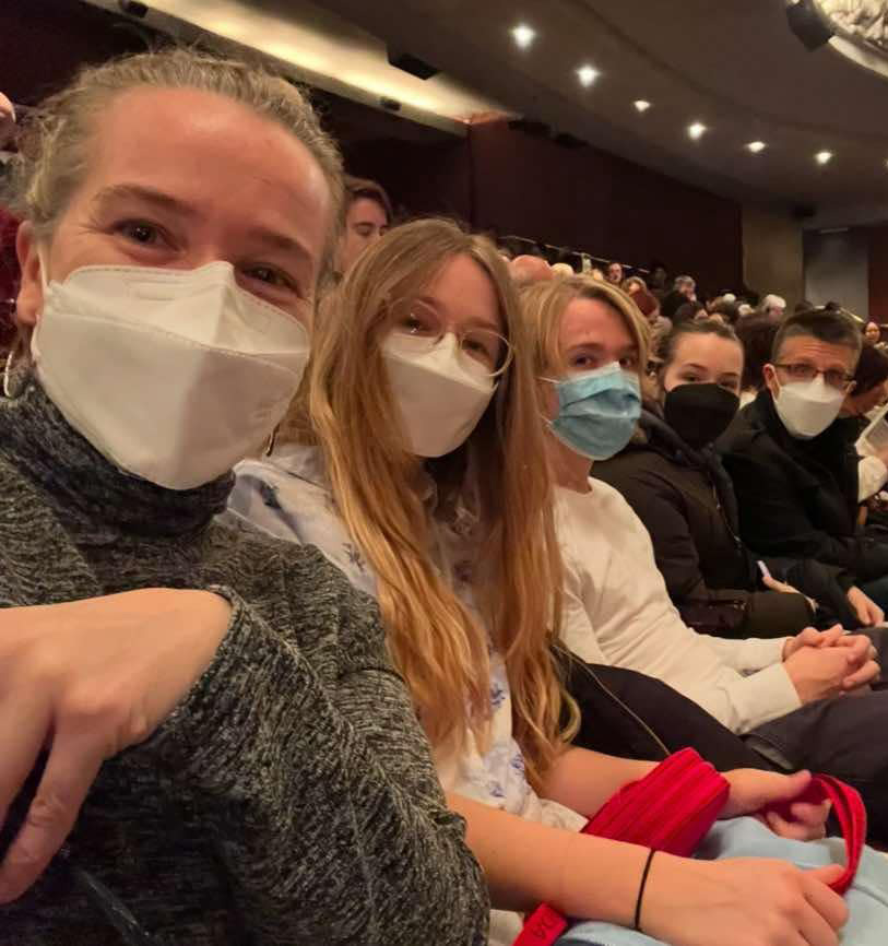 A group of people wearing N95 masks at a public performance.